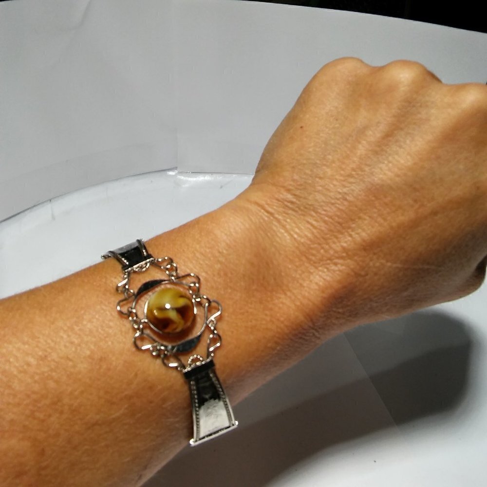 Women`s silver tone faux amber wire bracelet.